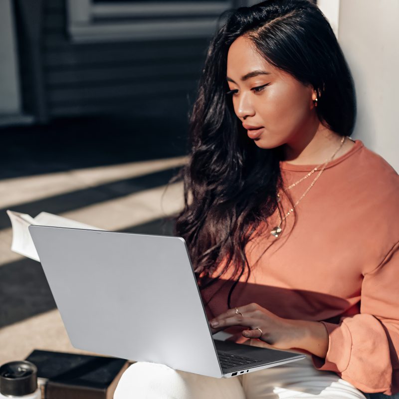 Woman working on a laptop.