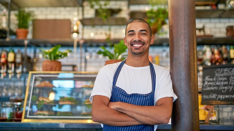 A young entrepreneur standing in his business.